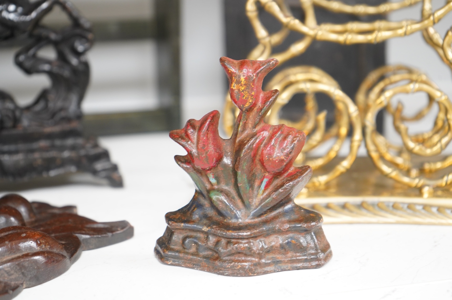 Sundry items to include an iron money box, brass letter rack, horse door stop and a 19th century oak carving, largest 32cm high